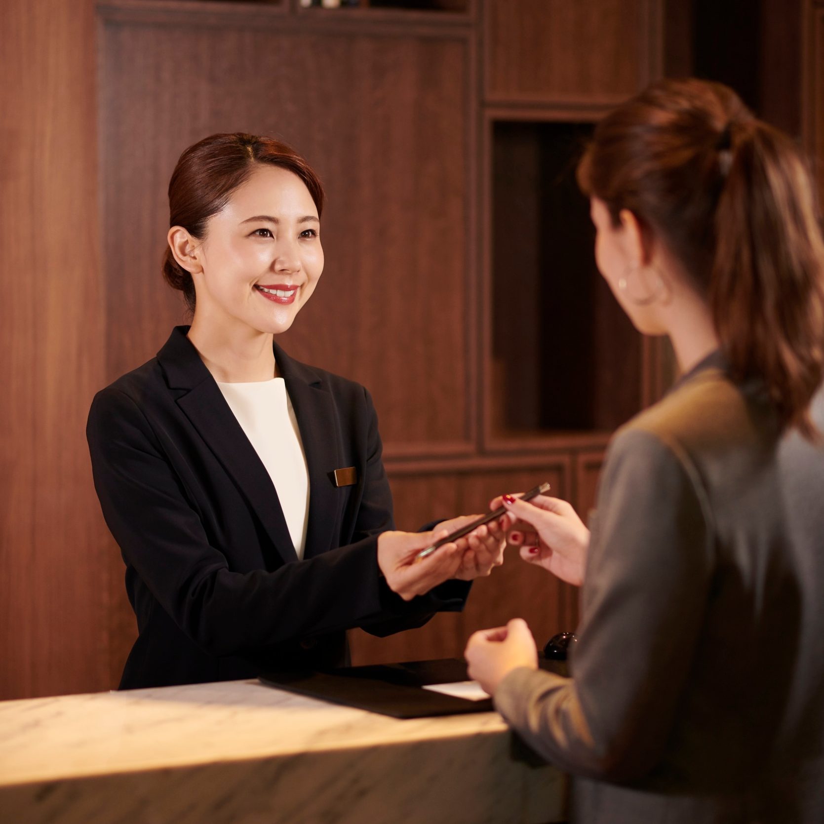 Woman giving a key to the guest