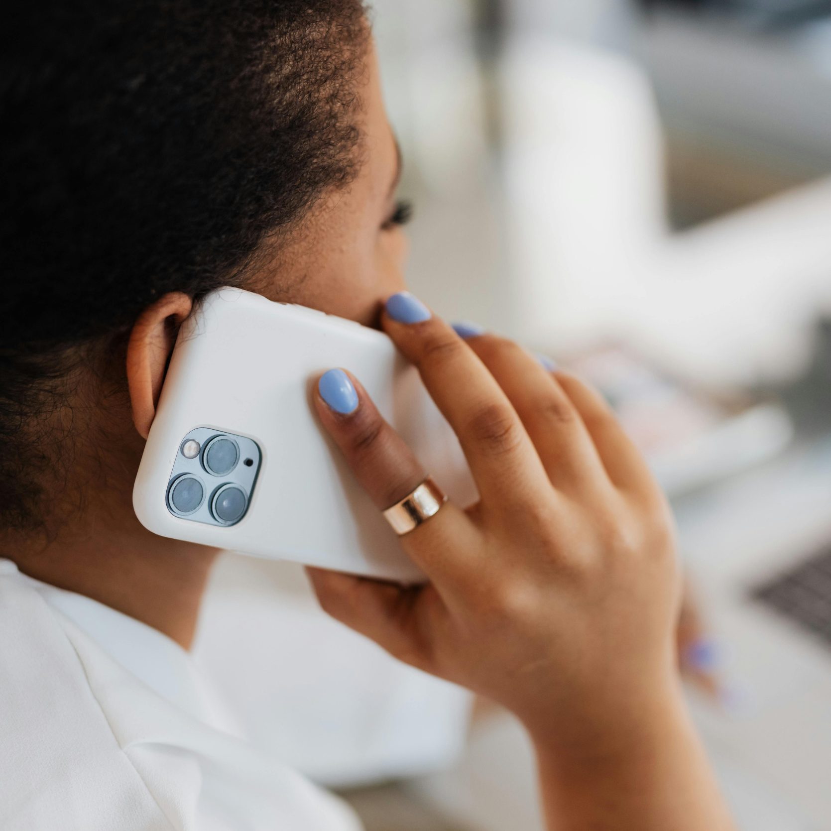 Woman answering a call through phone